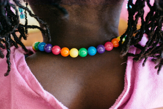 Rainbow color necklace on a young African American girl