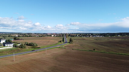 Fototapeta premium Top view of an asphalt road in the fields