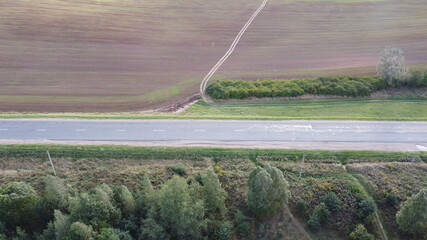 Top view of an asphalt road in the fields