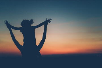 Mother and daughter enjoying a sunset in nature, away from the city