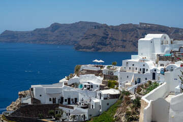 Fototapeta na wymiar Beautiful view of Oia, the famous town with its typical white houses on a sunny day. Santorini island, Cyclades, Greece, Europe.