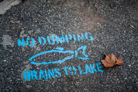 No Dumping Stenciled on Asphalt
