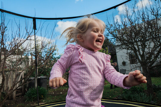 Cute litle girl having fun on trampoline