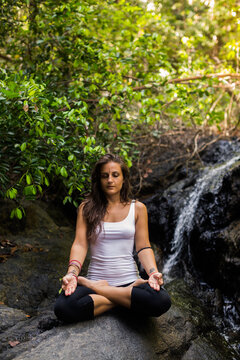 Young Woman Meditating in the Forest