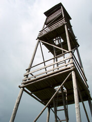 A low angle view of a wooden lookout tower in a countryside