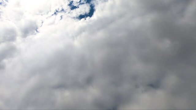 White rain clouds fly fast in the blue sky. TIMELAPSE video