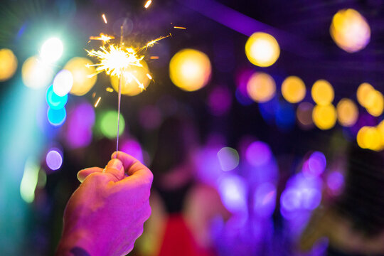 Man' hand holding a sparkler