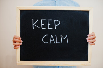 Keep calm. Coronavirus concept. Boy hold inscription on the board.