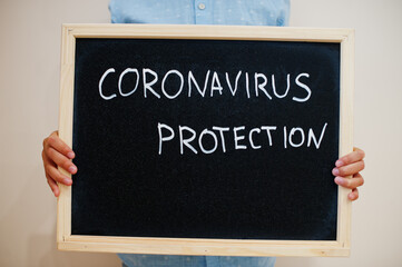 Covid protection. Coronavirus concept. Boy hold inscription on the board.