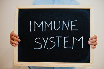 Immune system. Coronavirus concept. Boy hold inscription on the board.