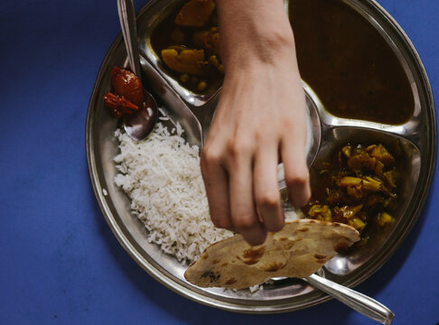 Hand grabing indian thali