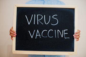 Fototapeta premium Virus vaccine. Coronavirus concept. Boy hold inscription on the board.