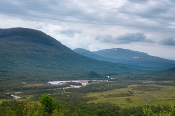 Fototapeta na wymiar Storulvån (Sweden). View of the mountains and the green valley.