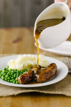 Bangers (sausages) and mash with onion gravy