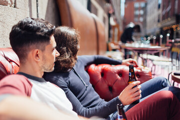 Two happy friends laughing and enjoying a beverage on a sailboat