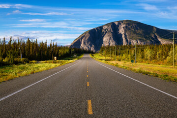 Scenic Route, Alaska Hwy, during a sunny and cloudy day. Mountains in Background. Near Haines Junction, West of Whitehorse, Yukon, Canada.