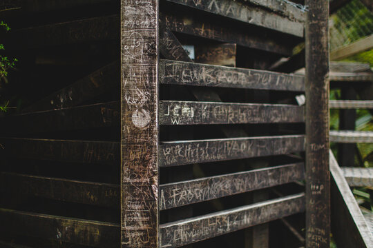 Writen planks of a wooden structure with a stair on a side