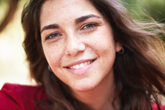 close up portrait of beautiful and smiling freckled woman