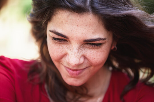 close up portrait of smiling woman looking down