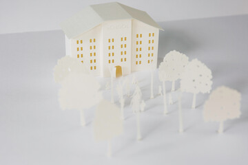 School building cut out of paper with its surroundings