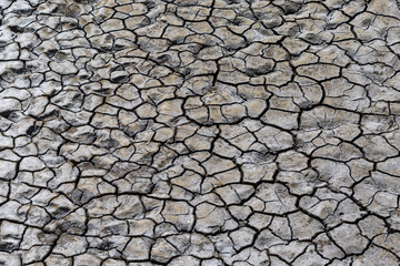 Part of a huge area of dried land suffering from drought in cracks..