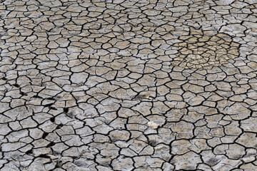 Part of a huge area of dried land suffering from drought in cracks..