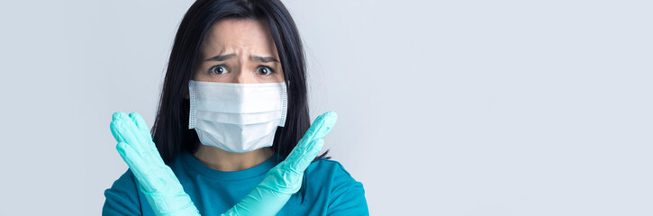 Portrait of anxious depressed girl feel fear about covid-19. Wear medical mask isolated over gray background.