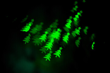 Bokeh in the shape of a Christmas tree. New year background. Selective focus