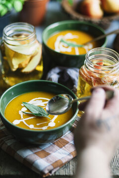 Butternut squash soup with sage and jugs of apple cider.