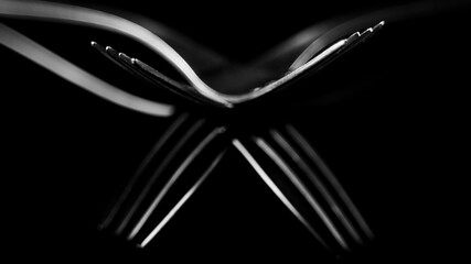 Composition made of forks on the black background.