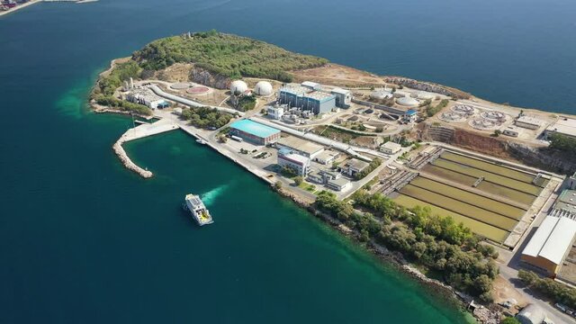 Aerial drone video of small island of Psitaleia a latest technology industrial sewage plant near port of Piraeus, Attica, Greece
