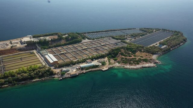 Aerial drone video of small island of Psitaleia a latest technology industrial sewage plant near port of Piraeus, Attica, Greece