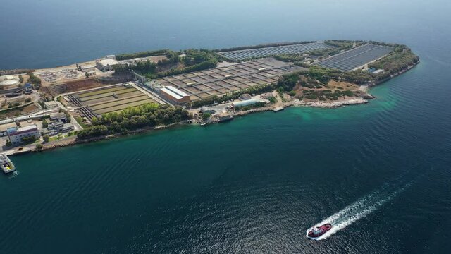 Aerial drone video of small island of Psitaleia a latest technology industrial sewage plant near port of Piraeus, Attica, Greece