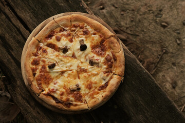Homemade mushroom pizza on wood plate
