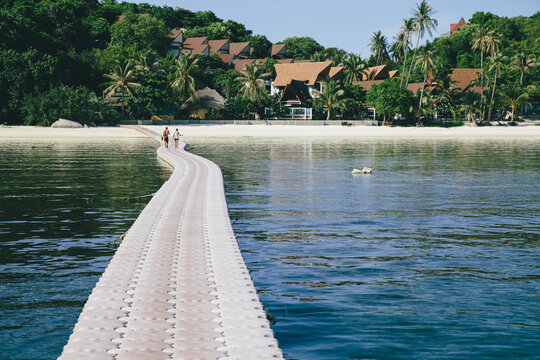 Couple walking at pier in tropics