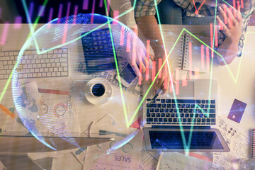 Double exposure of man and woman working together and financial graph hologram drawing. market analysis concept. Computer background. Top View.