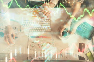 Double exposure of man and woman working together and financial chart hologram drawing. market analysis concept. Computer background. Top View.