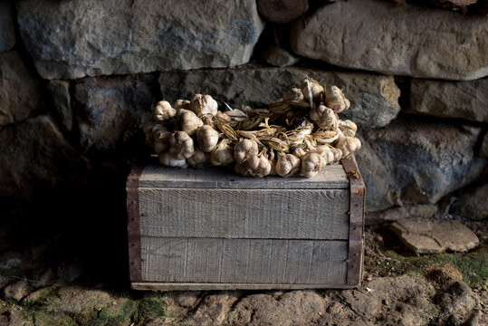 Garlic braid on old wooden crate