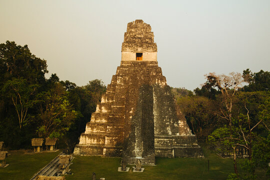 Tikal Pyramid Ruins in Guatemala light up as the sun goes down