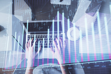 Double exposure of woman hands working on computer and forex chart hologram drawing. Top View. Financial analysis concept.