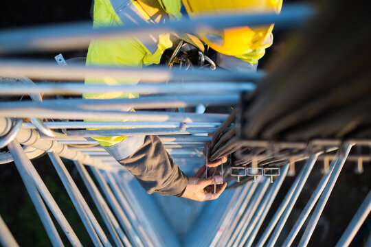 Working at heights, technician climbs up on a communications tower