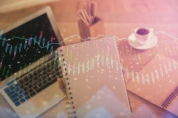 Double exposure of businesswoman hands typing on computer and forex chart hologram drawing. Financial analysis concept.