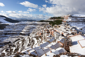Mediterranean snowy mountain village on mountainside