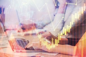 Multi exposure of woman hands typing on computer and financial chart hologram drawing. Stock market analysis concept.