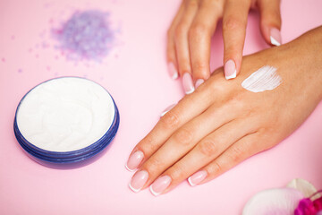 Obraz na płótnie Canvas Woman applying hand cream at home, closeup