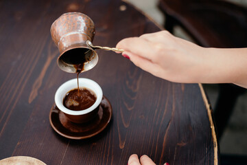 Drinking Turkish coffee boiled in pot (cezve)