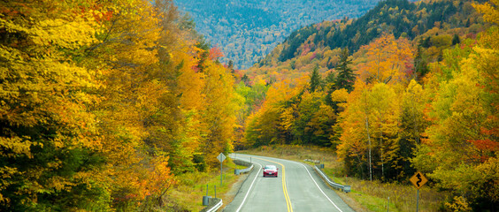 Lost River Road (Hwy 112) winds through a hardwood forest with trees showing peak fall color, west...