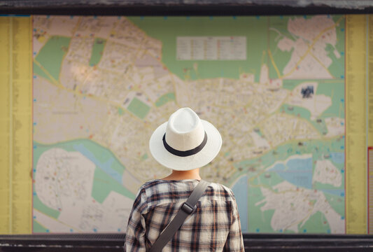 Woman standing in front of large map