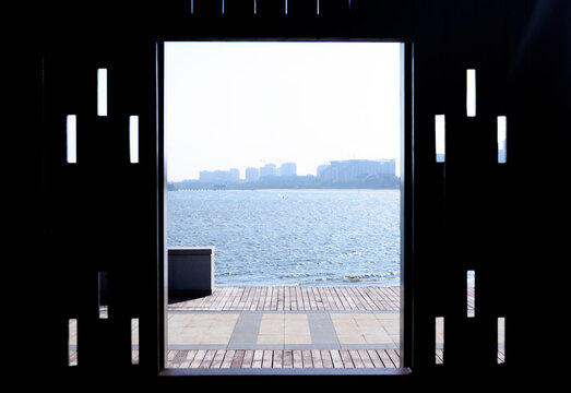 View of the sea on seashore through pavement in garden