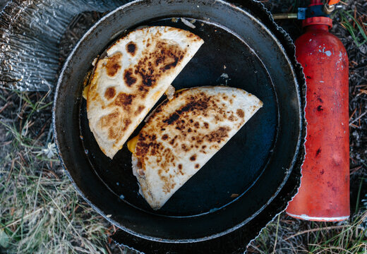 Quesadillas cooking on camping stove outdoors